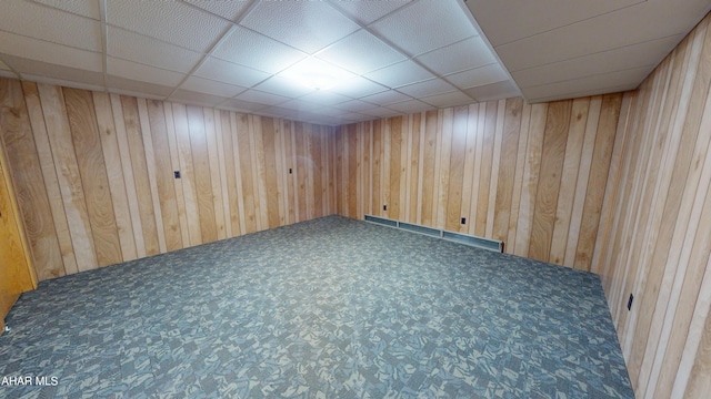 79 Mill Rd, Duncansville, PA 16635 - unfurnished room with carpet flooring, wooden walls, a paneled ceiling, and baseboard heating