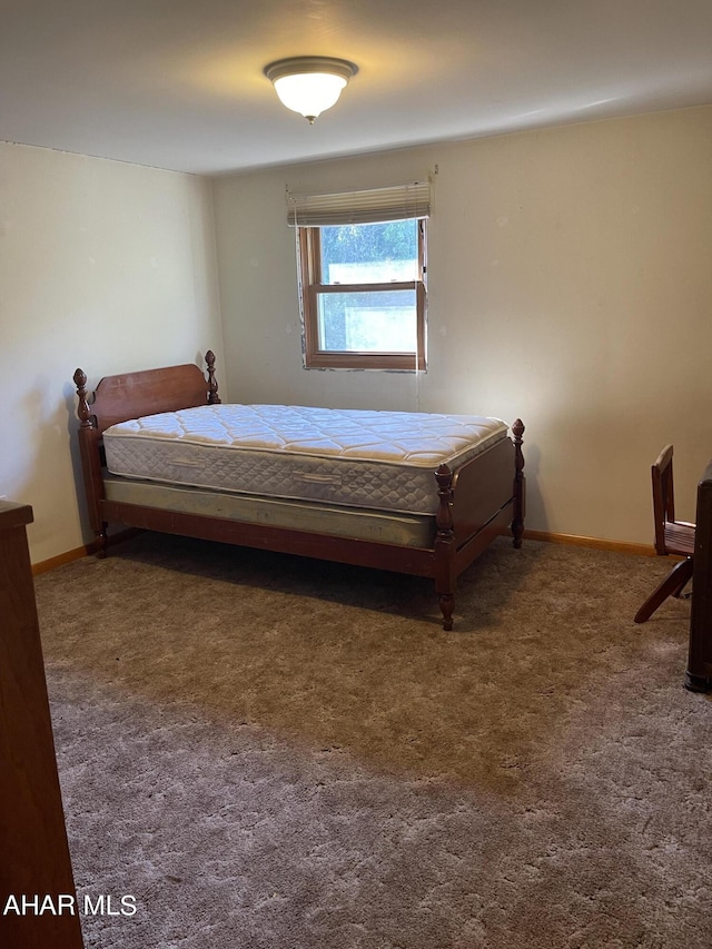 bedroom with dark colored carpet