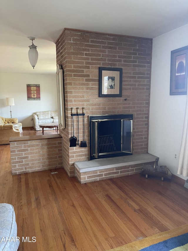 details with wood-type flooring and a brick fireplace