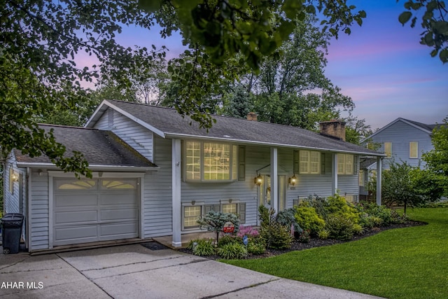 4701 Lynndale Rd, Altoona, PA 16602 - split foyer home featuring an attached garage, a lawn, a chimney, driveway, and a shingled roof