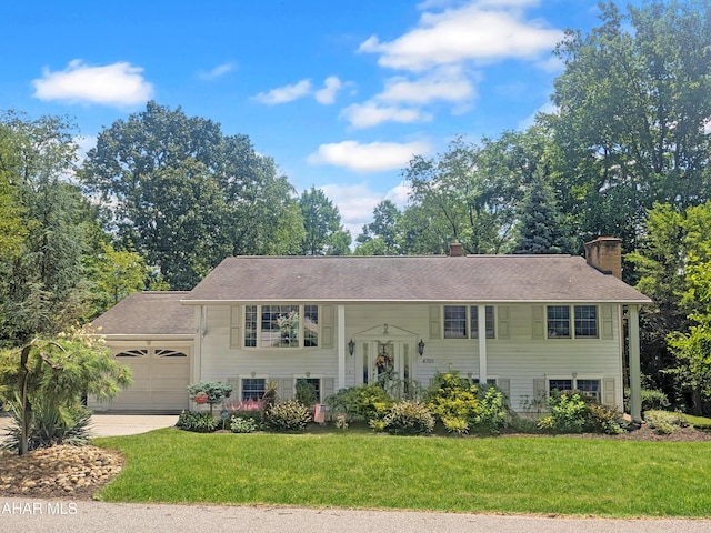 4701 Lynndale Rd, Altoona, PA 16602 - raised ranch with a chimney, an attached garage, a front yard, and concrete driveway