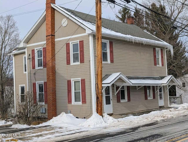 view of snowy exterior featuring a porch