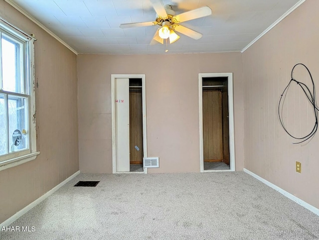 carpeted spare room featuring ceiling fan and ornamental molding