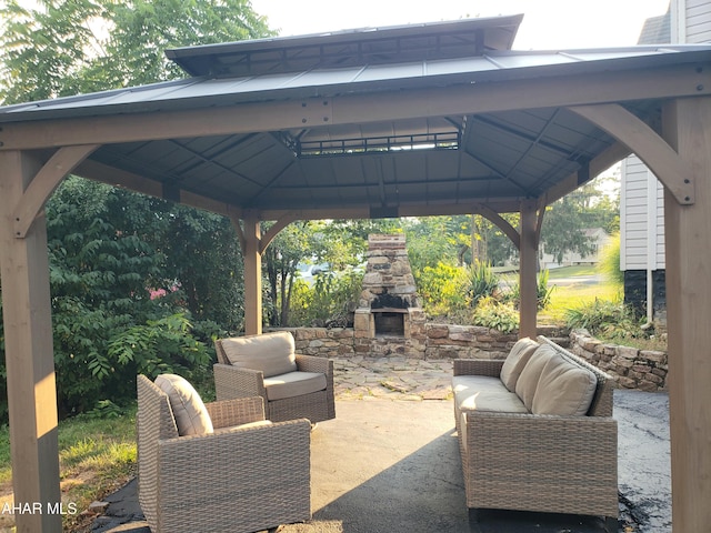 view of patio featuring a gazebo and an outdoor living space with a fireplace