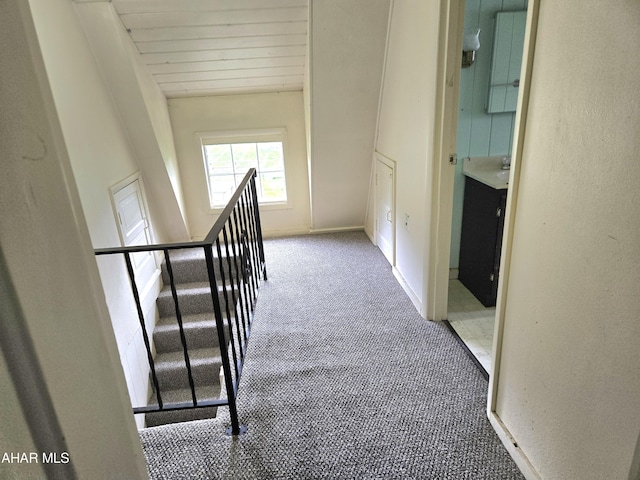 hall with carpet flooring and wood ceiling