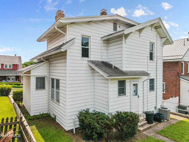 1108 22nd Ave, Altoona, PA 16601 - rear view of house featuring a chimney, central AC, and entry steps