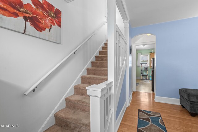 1108 22nd Ave, Altoona, PA 16601 - staircase with arched walkways, wood finished floors, and baseboards