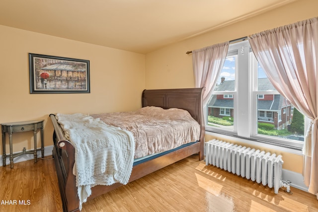 1108 22nd Ave, Altoona, PA 16601 - bedroom featuring radiator, multiple windows, and wood finished floors