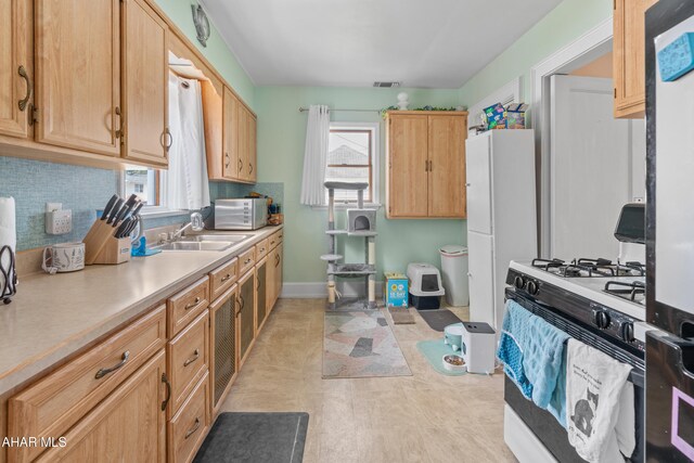 1108 22nd Ave, Altoona, PA 16601 - kitchen with white appliances, a sink, plenty of natural light, and light countertops