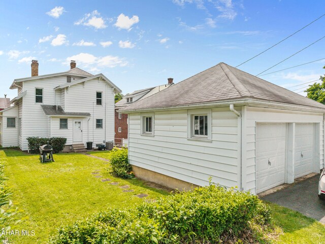 1108 22nd Ave, Altoona, PA 16601 - back of house with entry steps, a garage, a yard, and roof with shingles