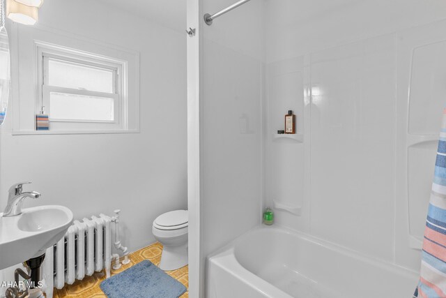 1108 22nd Ave, Altoona, PA 16601 - full bathroom featuring radiator, toilet, shower / bath combo with shower curtain, and tile patterned flooring
