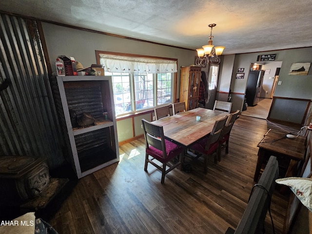 dining area featuring a textured ceiling, a notable chandelier, and dark wood-type flooring