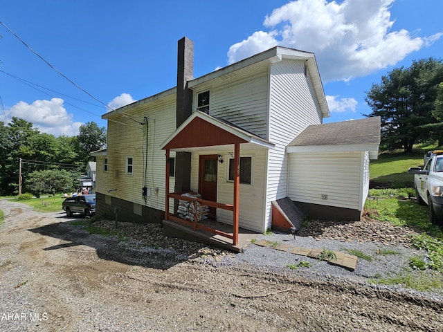 rear view of house featuring a porch