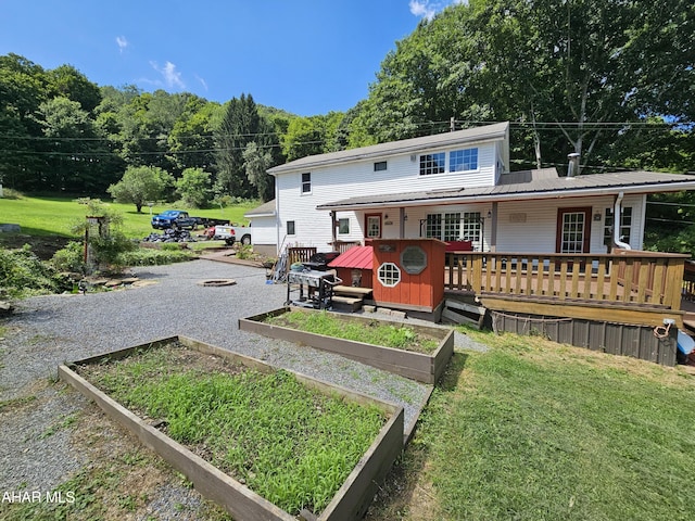 back of property featuring a yard and a porch