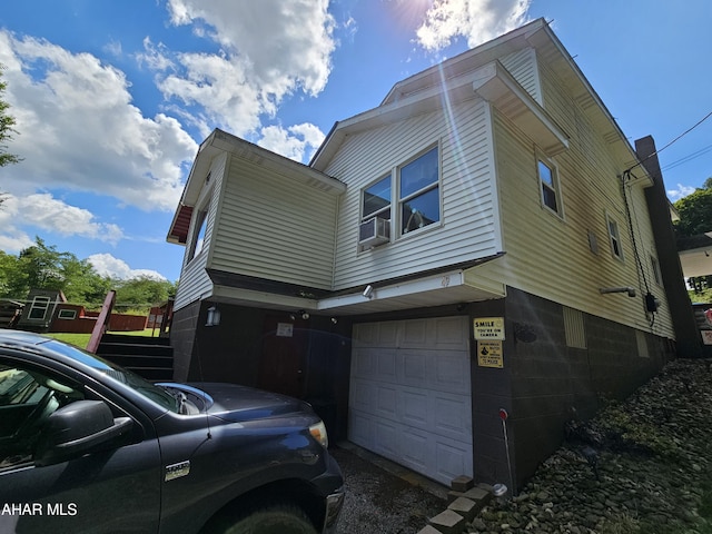 view of side of home featuring a garage