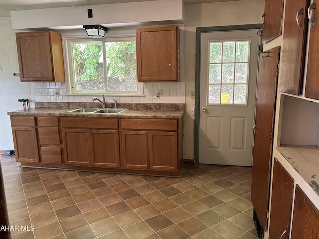 179 Orchard Way, Bedford, PA 15522 - kitchen featuring brown cabinetry, decorative backsplash, and dark countertops