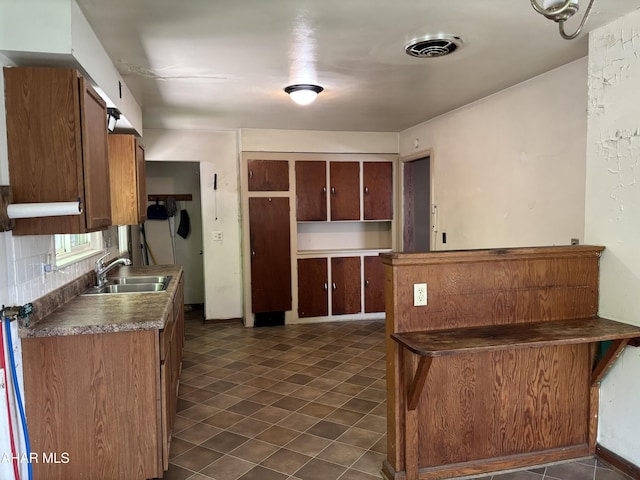 179 Orchard Way, Bedford, PA 15522 - kitchen with brown cabinetry and dark countertops