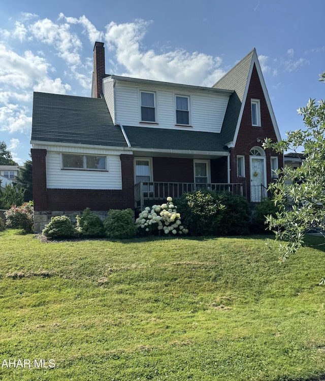 512 26th Ave, Altoona, PA 16601 - view of front of property with a chimney, a front yard, a porch, and brick siding