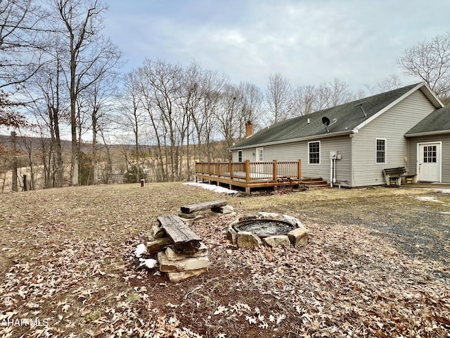 view of yard with an outdoor fire pit and a wooden deck