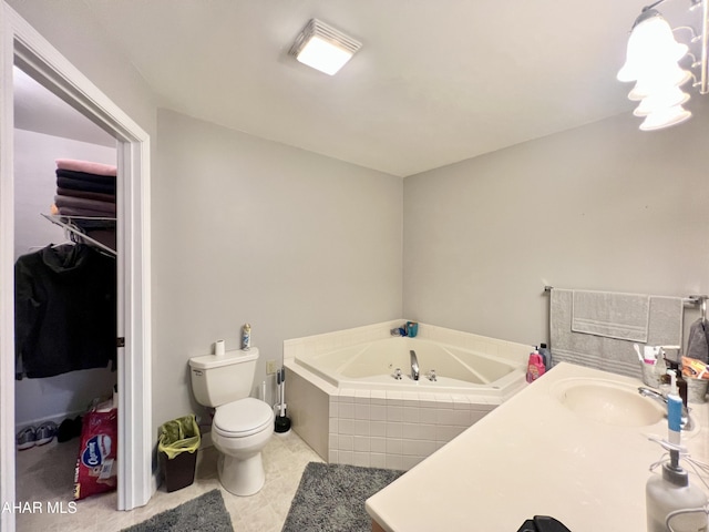 bathroom with a garden tub, a sink, toilet, and tile patterned floors