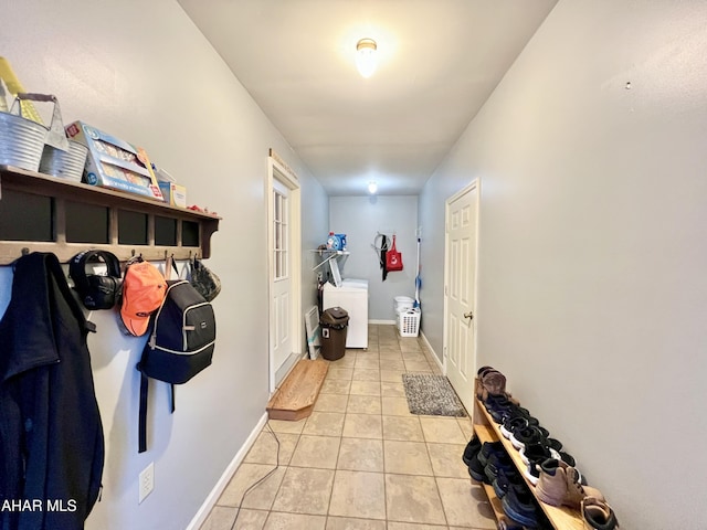 mudroom with washer / clothes dryer, baseboards, and light tile patterned floors