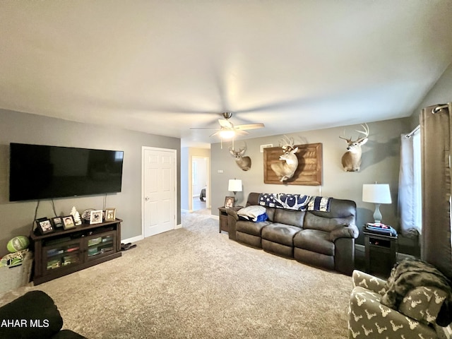 living area with carpet, a ceiling fan, and baseboards