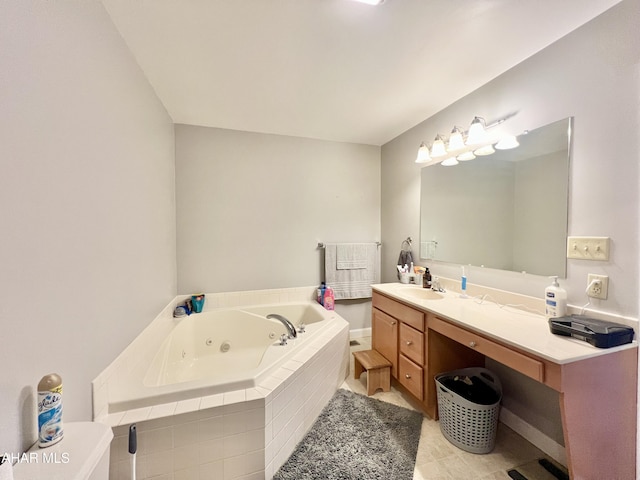 full bathroom with tile patterned floors, a tub with jets, and vanity