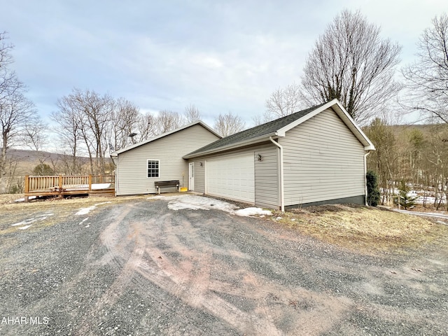 view of home's exterior featuring a deck and an outdoor structure