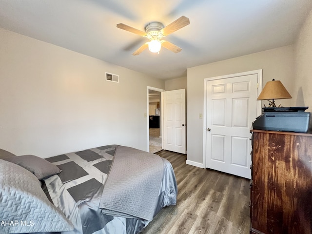 bedroom featuring visible vents, ceiling fan, baseboards, and wood finished floors