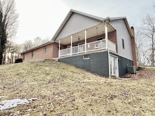 exterior space with central air condition unit and brick siding