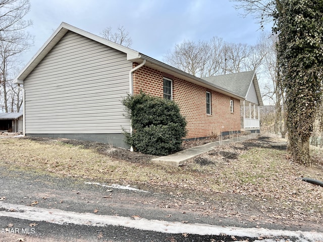 view of side of property with brick siding