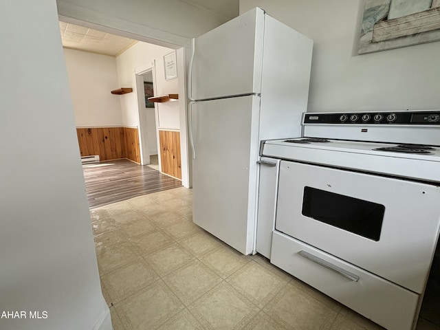 6 B St, Coudersport, PA 16915 - kitchen featuring white appliances, light floors, a wainscoted wall, a baseboard heating unit, and wood walls