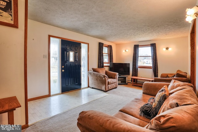 carpeted living room featuring a textured ceiling