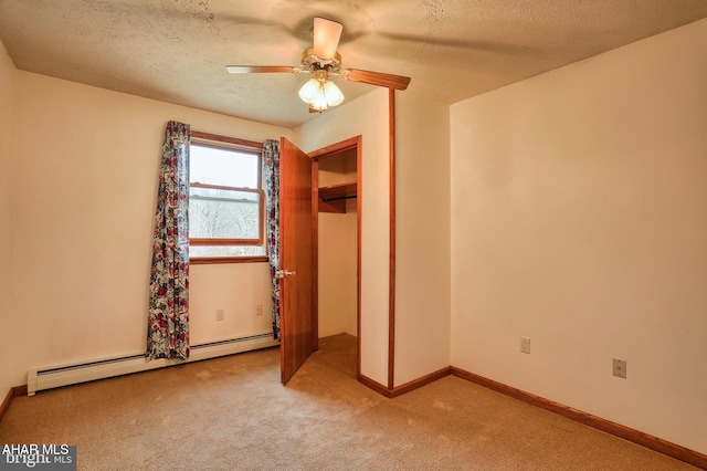 unfurnished bedroom with baseboard heating, ceiling fan, light carpet, and a textured ceiling