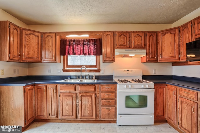 kitchen featuring sink, gas range gas stove, and a textured ceiling