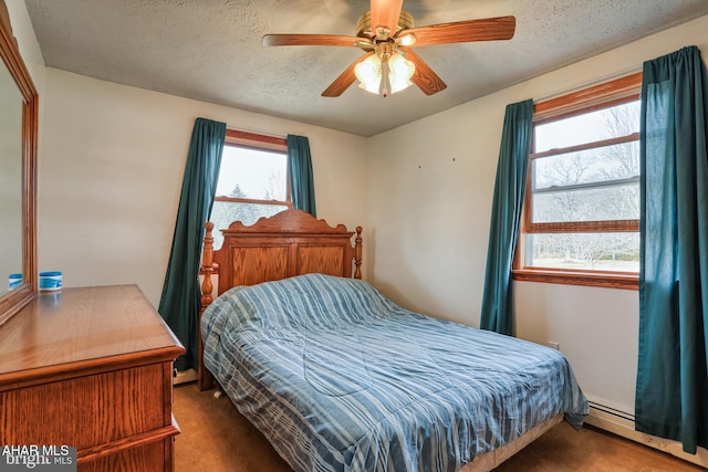 carpeted bedroom featuring ceiling fan, a textured ceiling, and a baseboard radiator