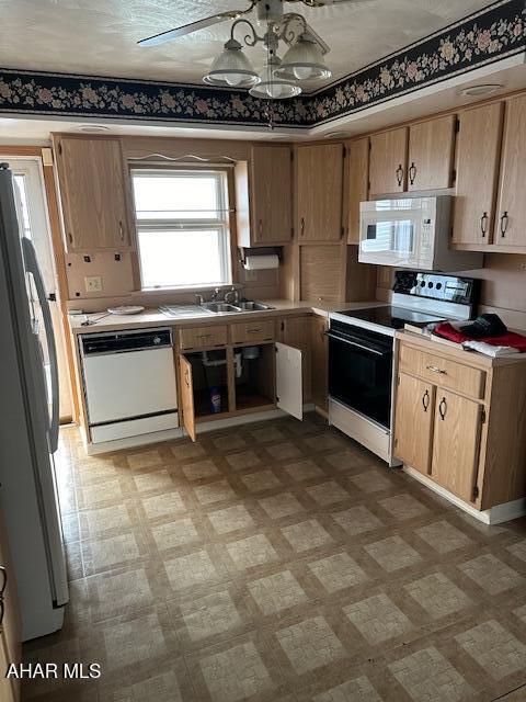 kitchen with ceiling fan, sink, and white appliances