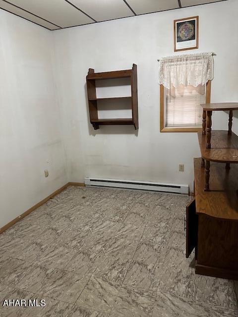 spare room featuring a baseboard heating unit