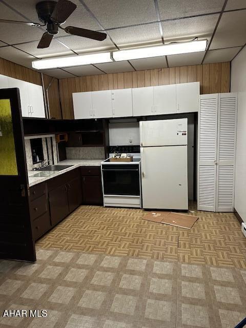 kitchen featuring electric range, dark brown cabinets, white refrigerator, and white cabinets