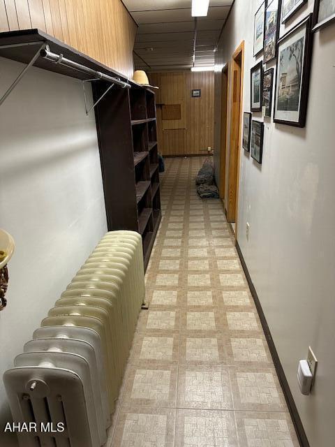 corridor with radiator and wooden walls