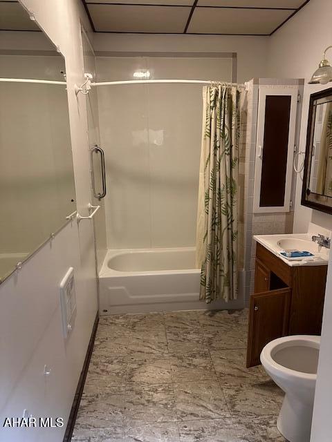 full bathroom with vanity, shower / bath combination with curtain, and toilet