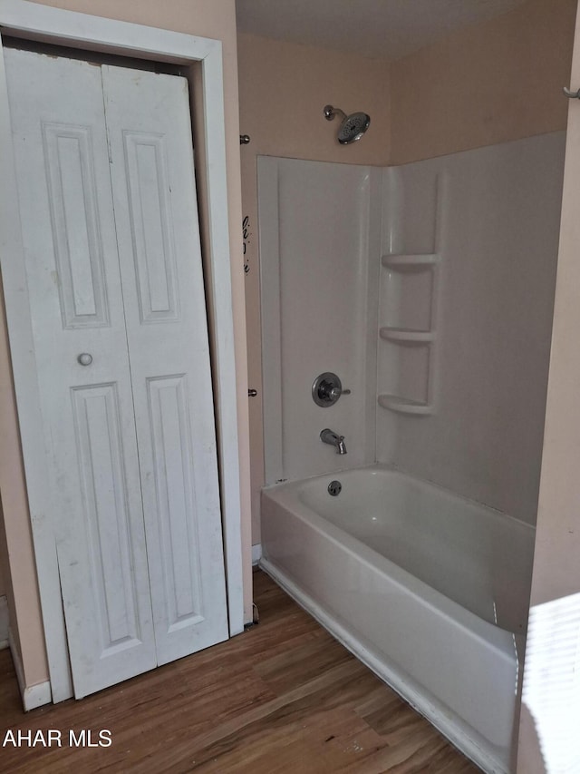 bathroom with shower / washtub combination and wood-type flooring