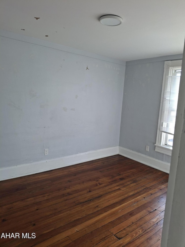 spare room featuring dark hardwood / wood-style floors