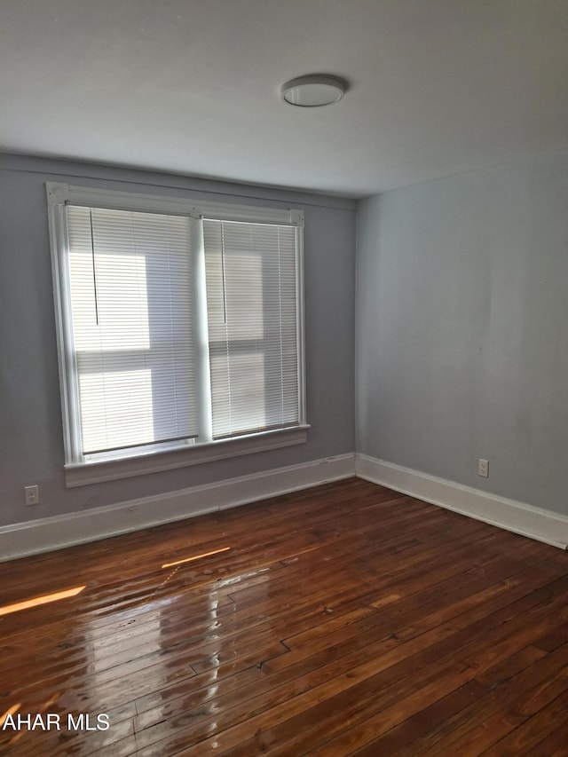 spare room featuring dark hardwood / wood-style floors