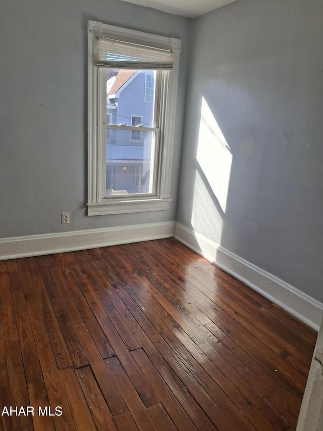 spare room with dark hardwood / wood-style floors