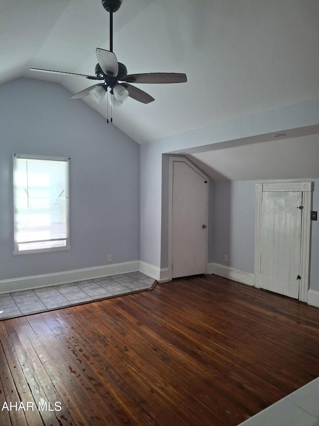 bonus room with ceiling fan, dark hardwood / wood-style flooring, and vaulted ceiling