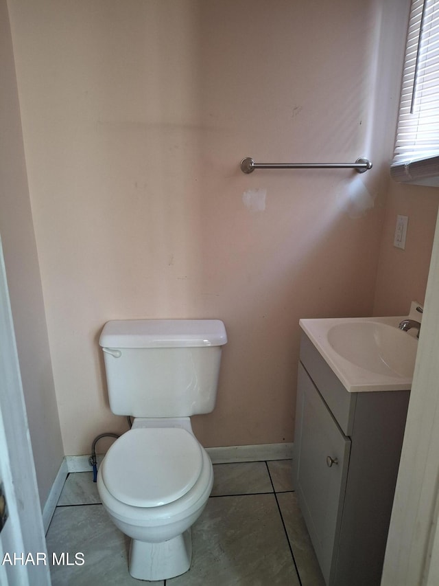 bathroom featuring tile patterned flooring, vanity, and toilet