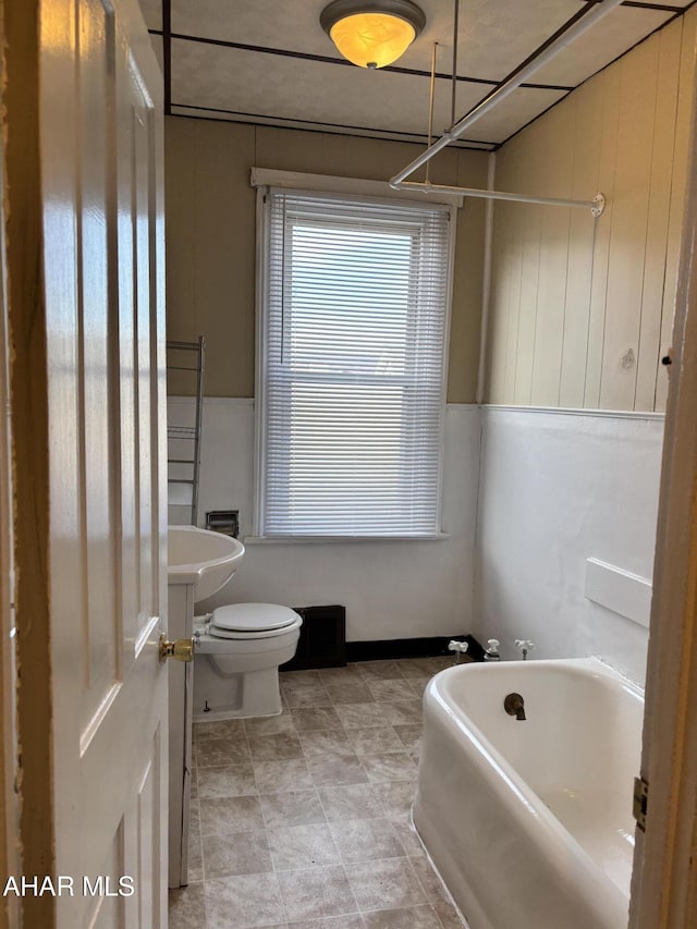 bathroom with a bathing tub and toilet