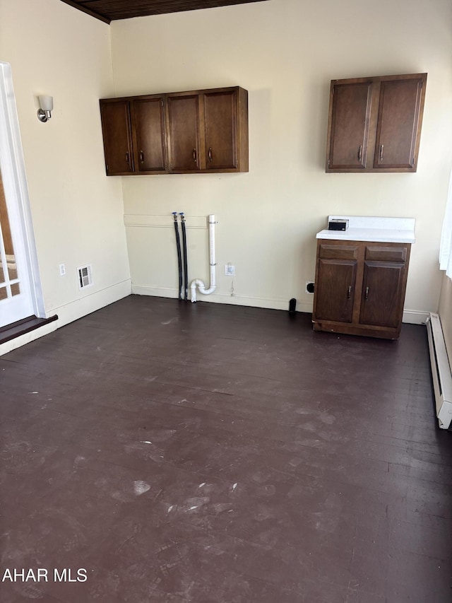 kitchen with dark brown cabinetry and baseboard heating