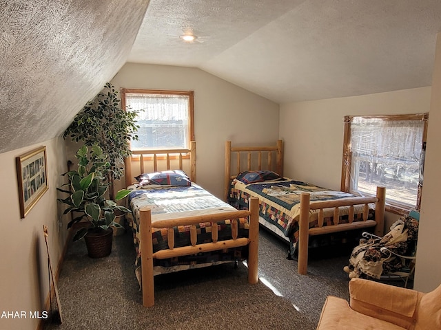 carpeted bedroom with vaulted ceiling and a textured ceiling